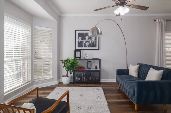 a living room with furniture and wooden floor