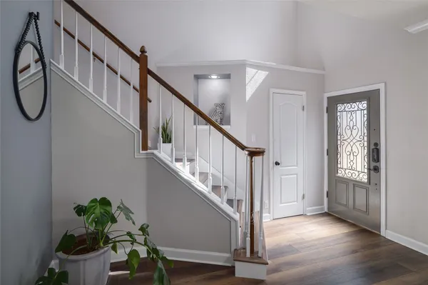 a view of entryway with wooden floor and stairs