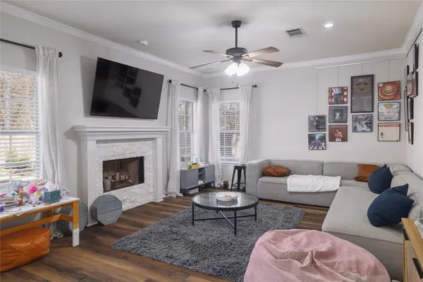 a living room with furniture fireplace and flat screen tv