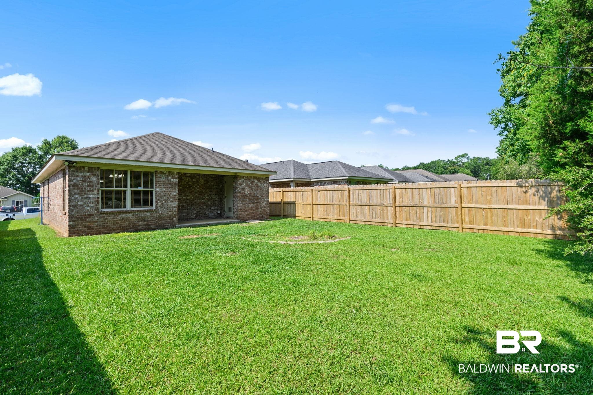8956 Spring Grove North Mobile, AL 36695 - Photo 16 of 19 Rear view of house with brick siding and roof with shingles