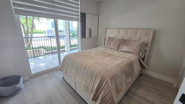 a bed sitting in a bedroom next to a window