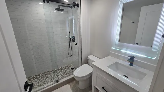 a bathroom with a sink toilet and shower