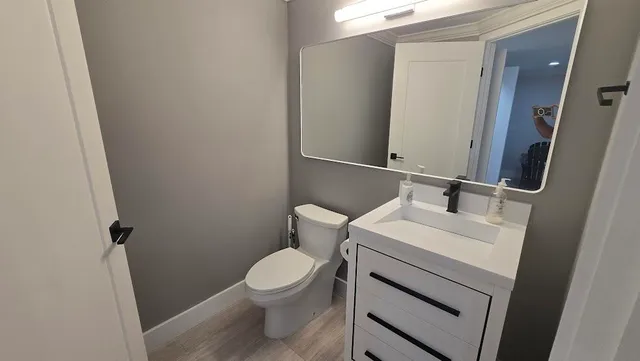 a white toilet sitting next to a white sink