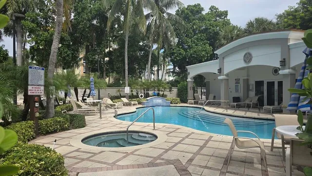 a view of a house with swimming pool and sitting area