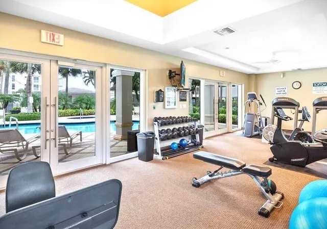 a room with gym equipment and a large window
