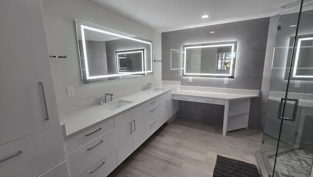 a bathroom with a double vanity sink a mirror and a bathtub