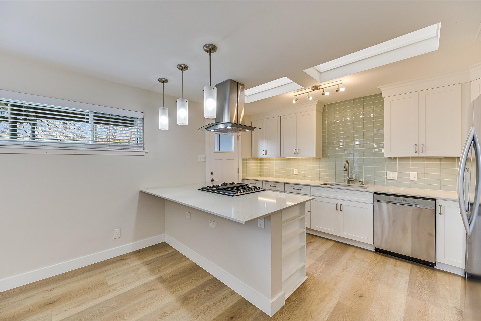1201 Dailey Street Austin, TX 78703 - Photo 7 of 14 a kitchen with stainless steel appliances granite countertop a sink a stove and a wooden floors