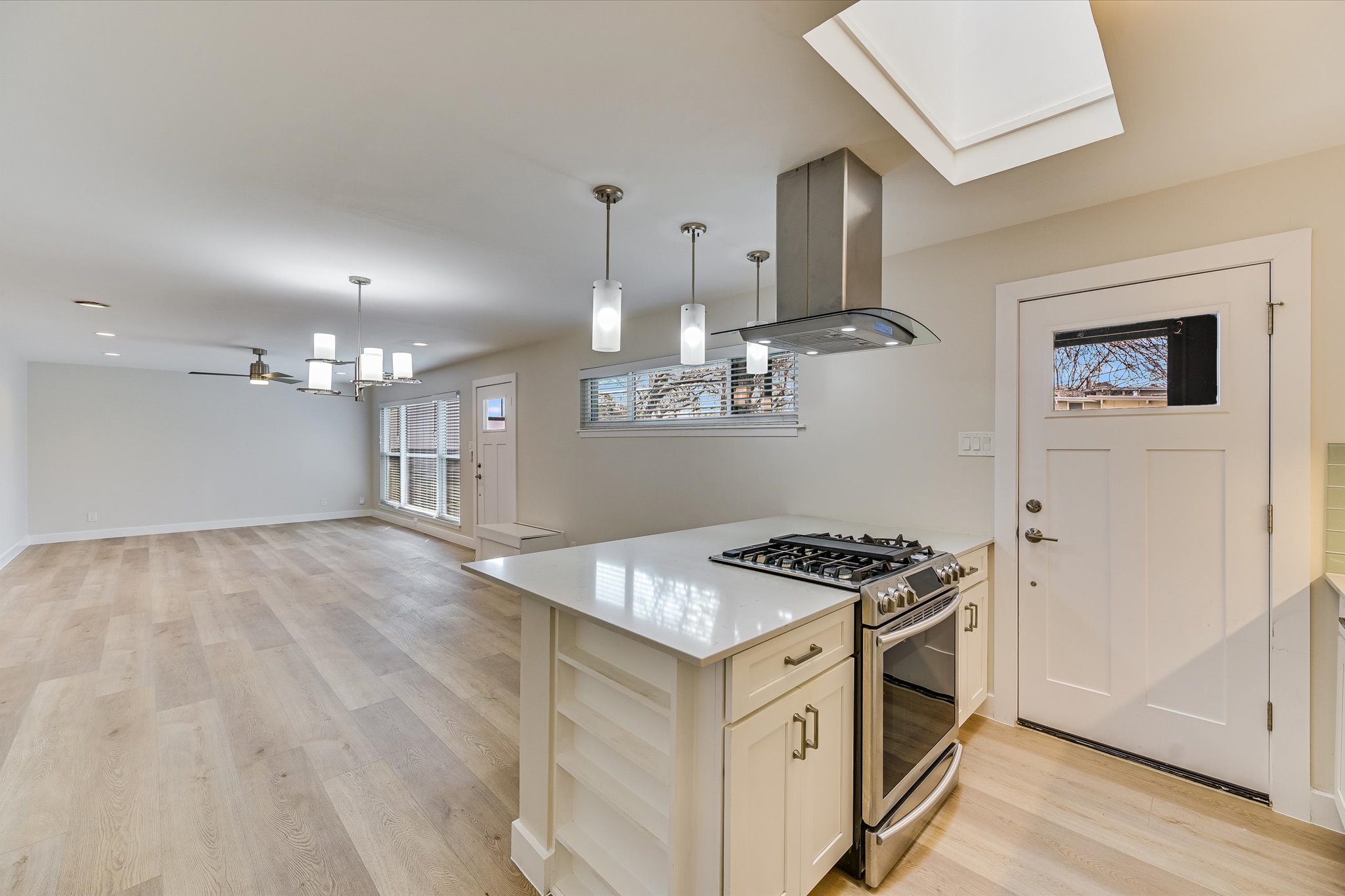 1201 Dailey Street Austin, TX 78703 - Photo 8 of 14 a kitchen that has a stove a microwave and white cabinets