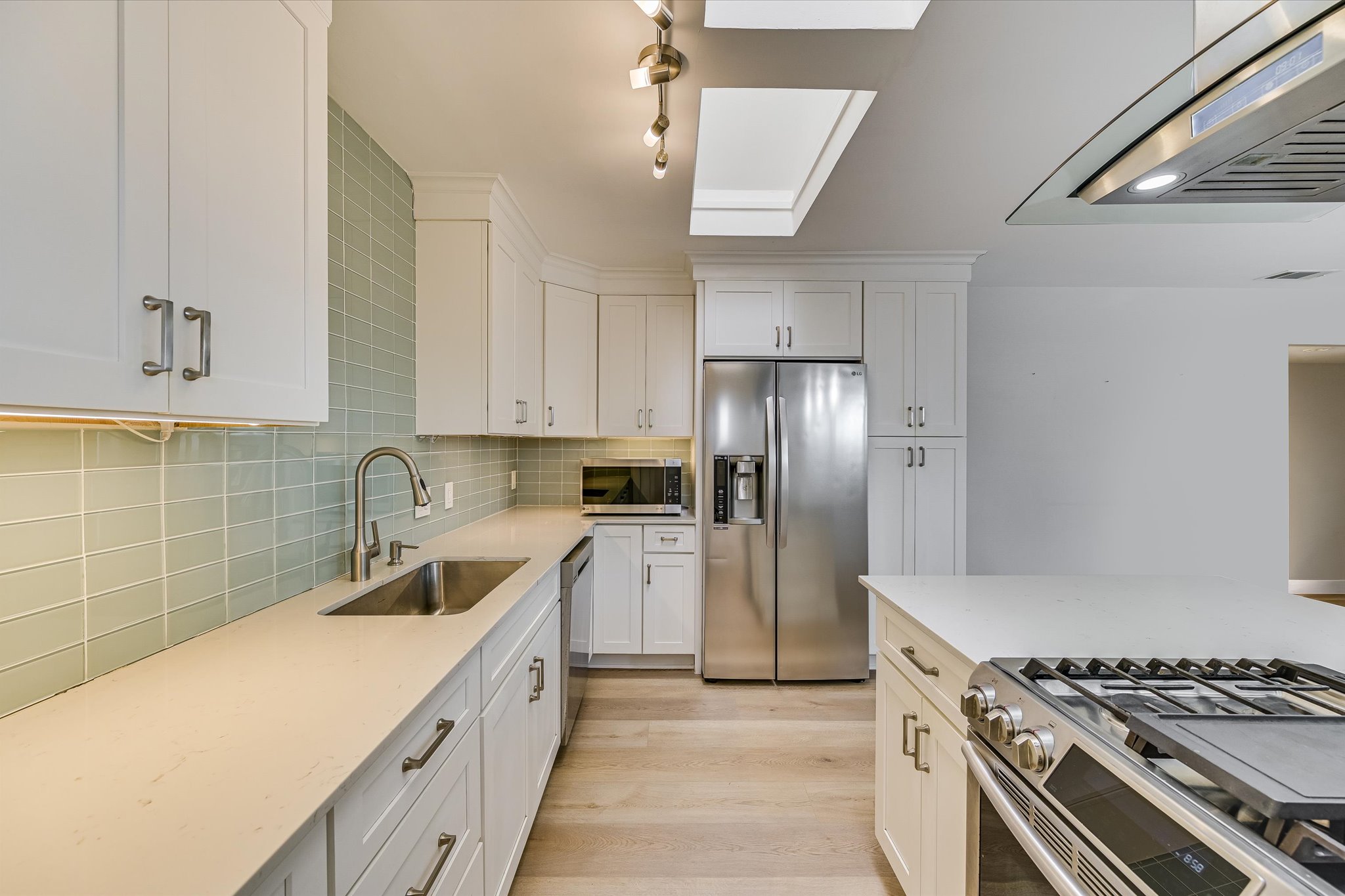 1201 Dailey Street Austin, TX 78703 - Photo 9 of 14 a kitchen with stainless steel appliances a sink stove and refrigerator