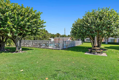 a garden with trees in front of it