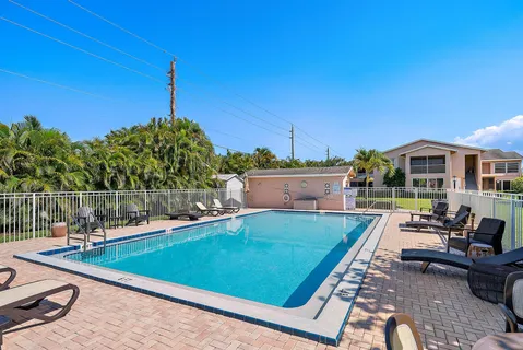 a view of a swimming pool with lounge chairs