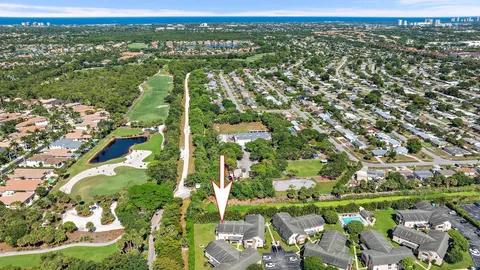 an aerial view of city lake and trees