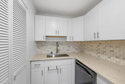 a kitchen with a sink and cabinets