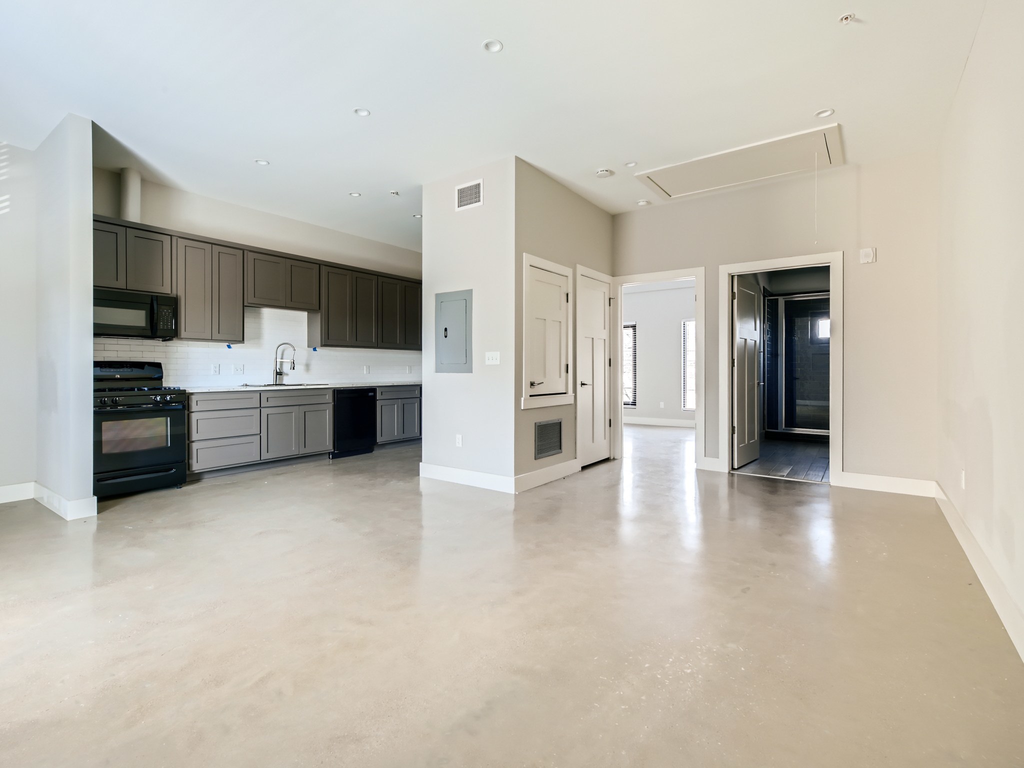 3523 Gonzalez Street, Unit 200 Austin, TX 78702 - Photo 4 of 10 Open-concept living area featuring light-toned flooring and recessed lighting