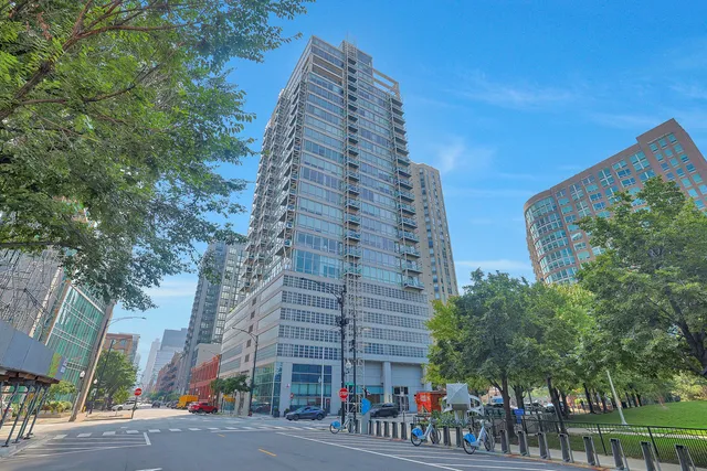 a view of a tall building next to a road