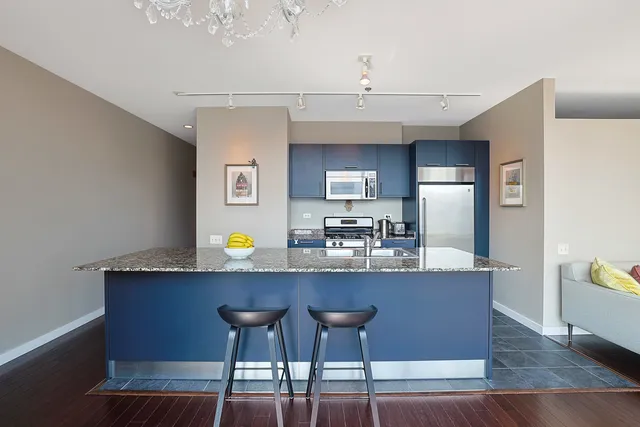 a living room with dining table and wooden floor