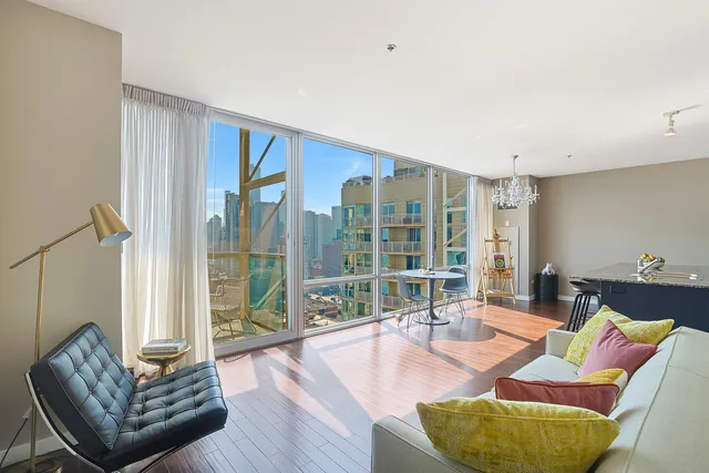 a living room with furniture gym equipment and a large window