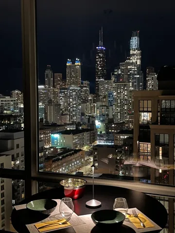 a dining room with furniture and a floor to ceiling window