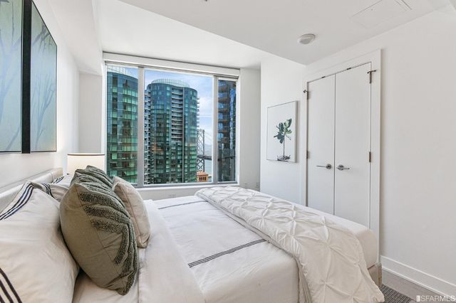 a bedroom with a bed and a night stand