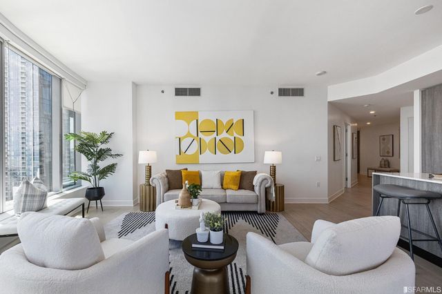a living room with furniture and a potted plant