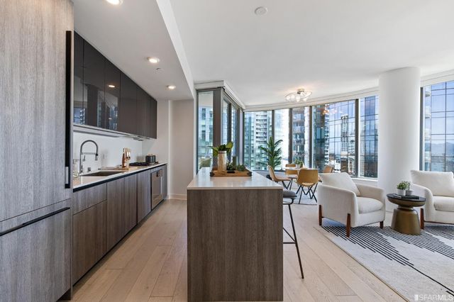 a very nice looking room with a large window and furniture