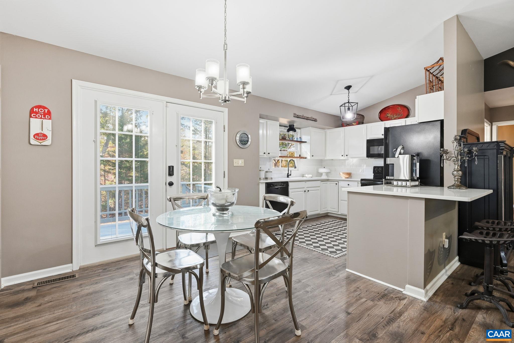 5356 Amicus Road Ruckersville, VA 22968 - Photo 20 of 46 a kitchen with kitchen island granite countertop a table and chairs in it