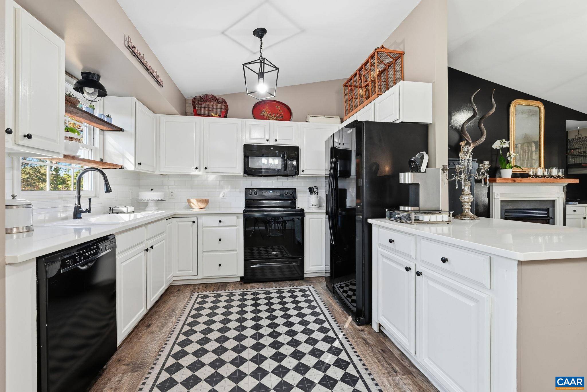 5356 Amicus Road Ruckersville, VA 22968 - Photo 21 of 46 a kitchen with a sink dishwasher white cabinets and black appliances