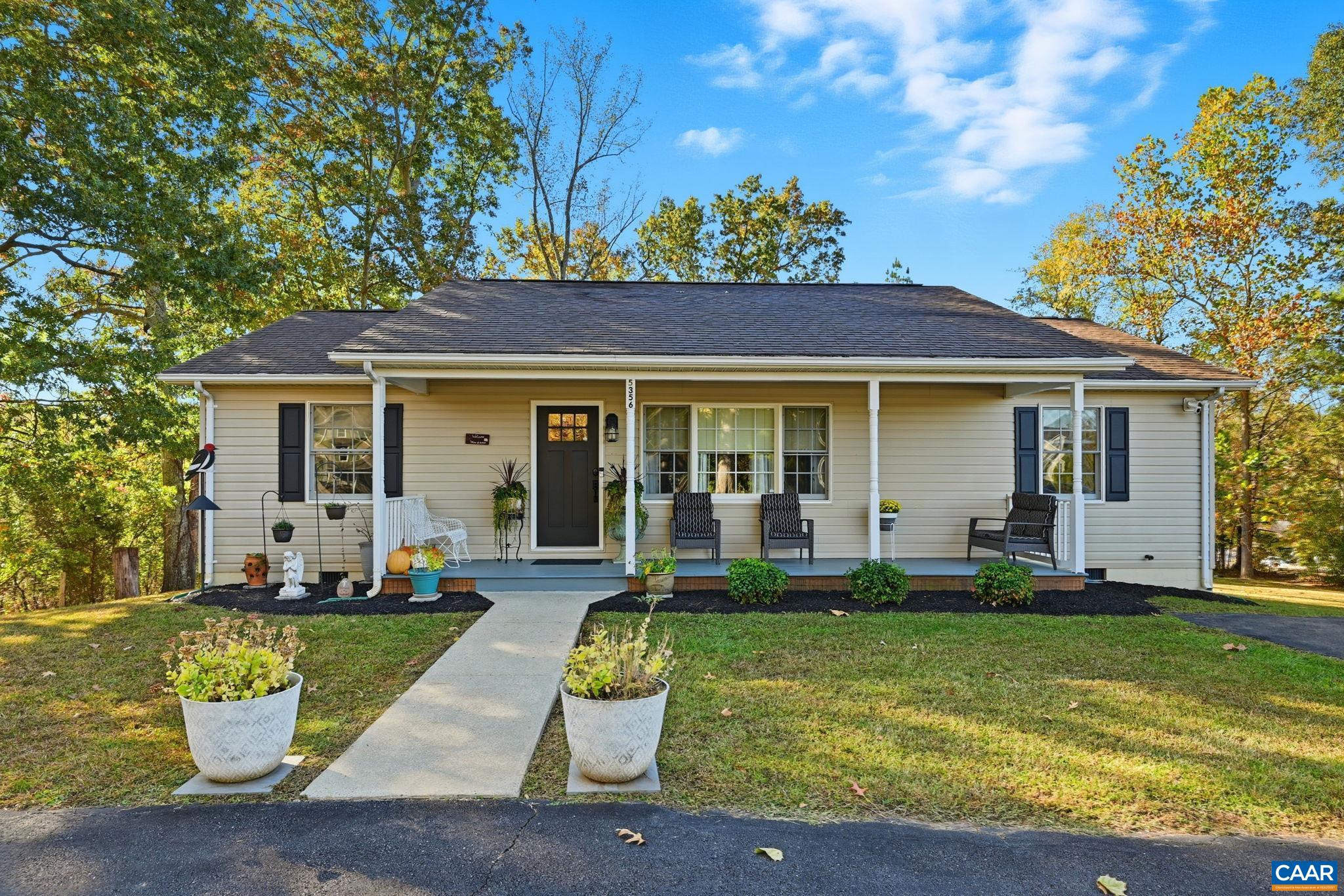 5356 Amicus Road Ruckersville, VA 22968 - Photo 32 of 46 a front view of a house with a yard table and chairs
