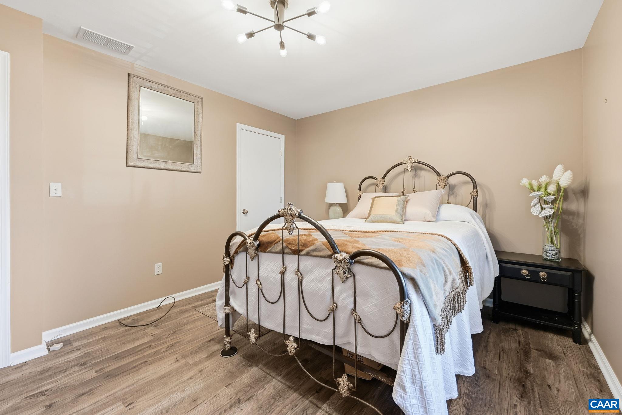 5356 Amicus Road Ruckersville, VA 22968 - Photo 5 of 46 a bedroom with a bed and painting on the wall