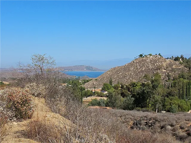 a view of a dry yard with mountains in the background
