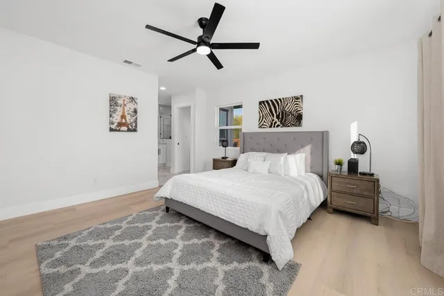 a bedroom with a bed and a painting on the wall