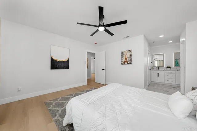 a bedroom with a bed and a painting on the wall