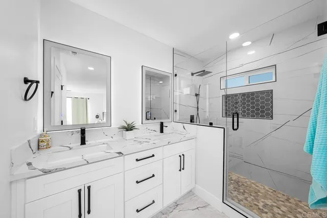 a bathroom with a granite countertop sink mirror and double