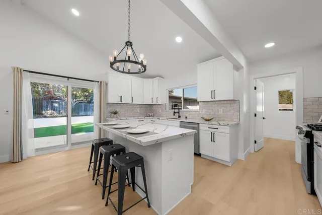a kitchen that has a lot of cabinets in it and appliances