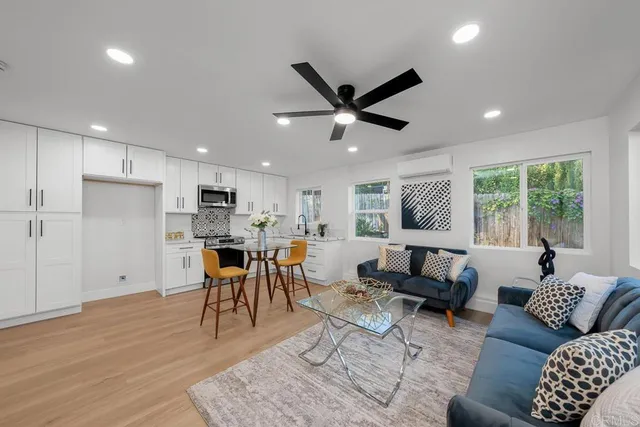 a living room kitchen with furniture and a large window