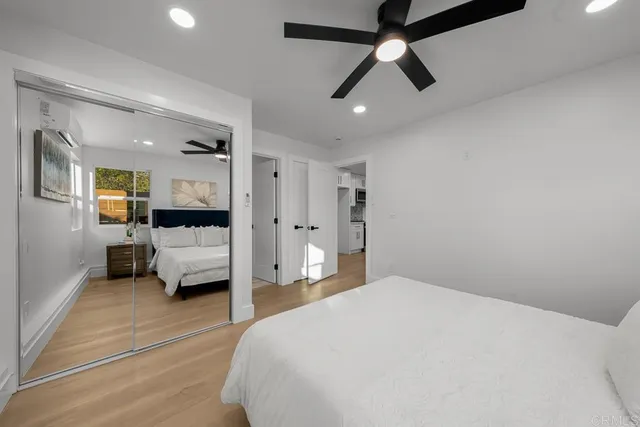 a bedroom with a bed and a large window