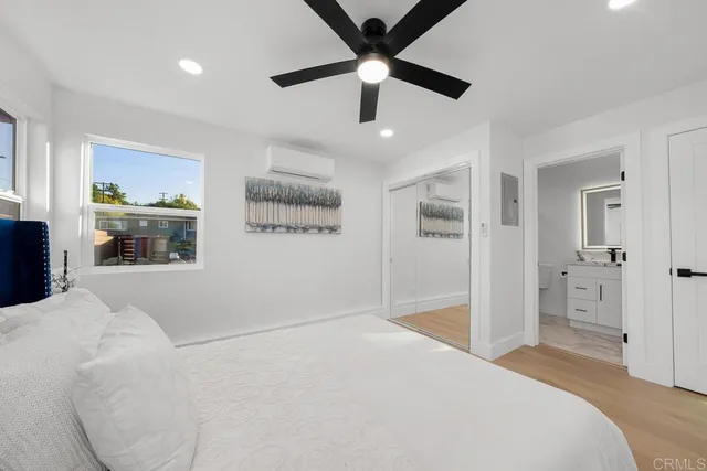 a bedroom with a large bed and a chandelier