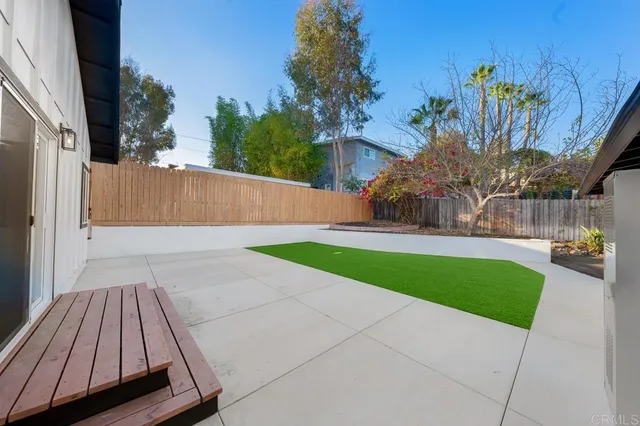 a view of backyard with seating and green space