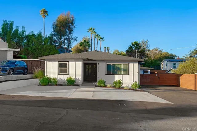 a front view of a house with a yard and a garage