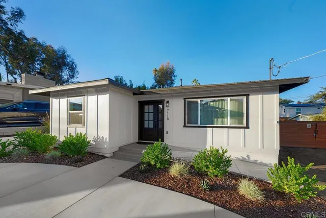 a front view of a house with garden