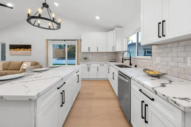 a kitchen with stainless steel appliances a sink stove and cabinets