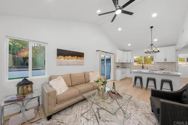 a living room with furniture and kitchen view