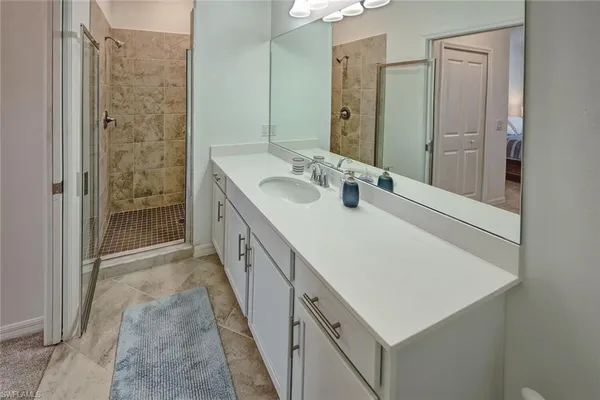 a bathroom with a double vanity sink and a mirror