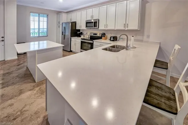 a view of a dining room with furniture and a kitchen