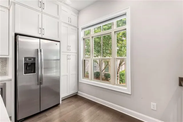 a metallic refrigerator freezer sitting in a kitchen