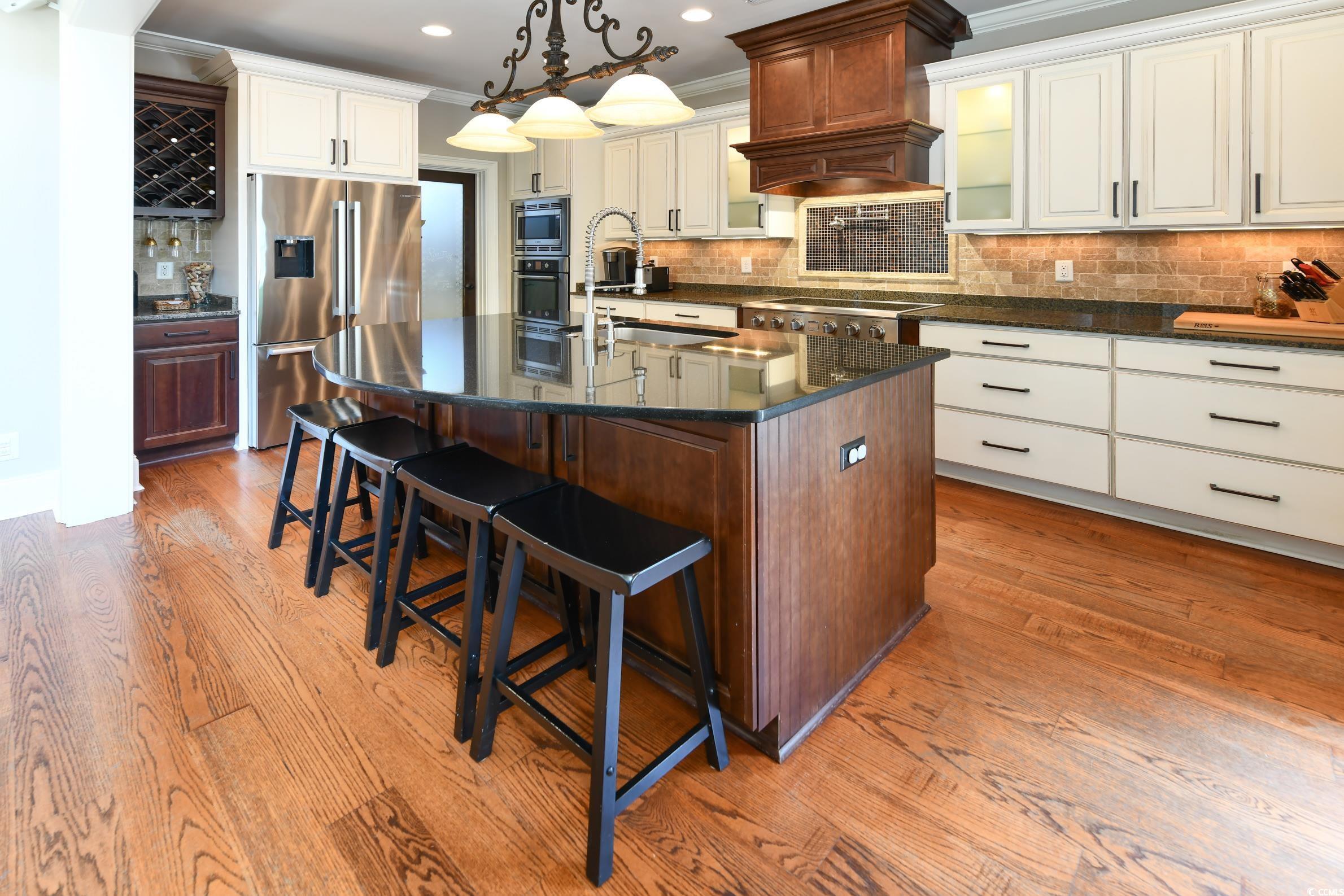 25 Orchard Avenue Murrells Inlet, SC 29576 - Photo 5 of 40 Kitchen with decorative backsplash, hardwood / woo