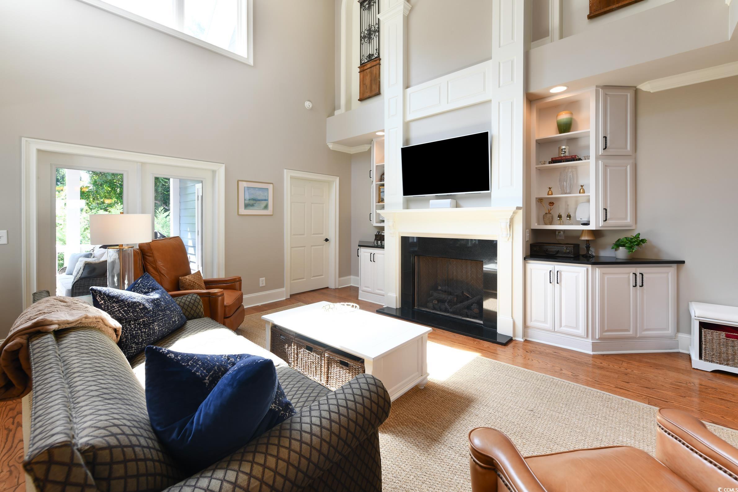25 Orchard Avenue Murrells Inlet, SC 29576 - Photo 10 of 40 Living room featuring built in shelves, light hard