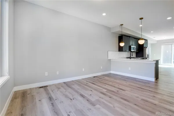 a view of kitchen with cabinets and wooden floor
