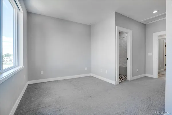 an empty room with windows and closet