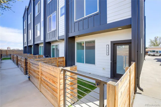 a view of a brick building with many windows and yard